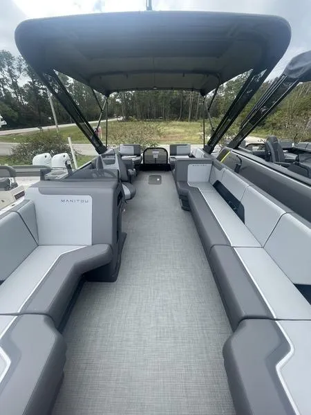 Slide: The Image of 2024 Manitou 22 Cruise FLEBRF Stealth pontoon boat interior with spacious seating. - 6