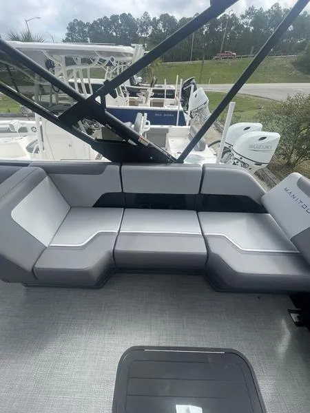 Slide: The Image of 2024 Manitou 22 Cruise Flebrf Stealth boat with modern seating and sleek design. - 9