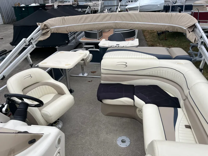 Slide: The Image of 2009 Bennington 2275 GS pontoon boat with beige seating and canopy. - 1