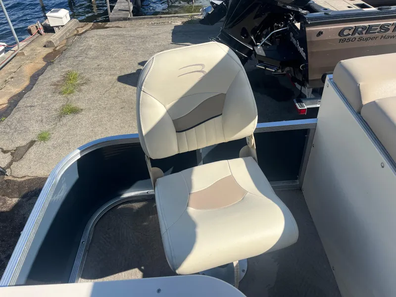 Slide: The Image of 2009 Bennington 2275 GS boat seat, beige and tan, dockside view. - 11