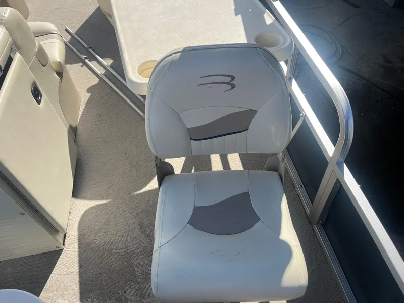 Slide: The Image of 2009 Bennington 2275 GS boat interior with cushioned seating and table. - 12