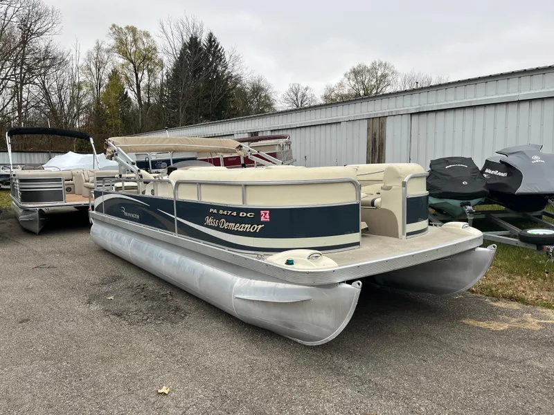 Slide: The Image of 2009 Bennington 2275 GS pontoon boat parked outdoors. - 2