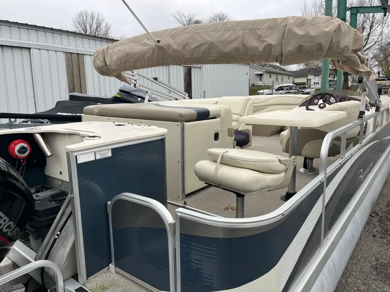 Slide: The Image of 2009 Bennington 2275 GS pontoon boat with beige seating and covered canopy. - 6