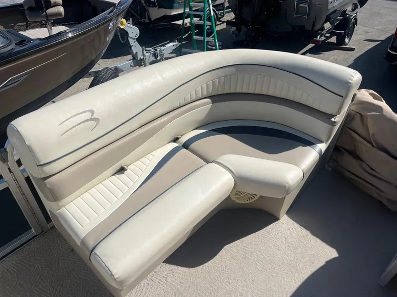 Slide: The Image of 2009 Bennington 2275 GS boat seating, beige and white upholstery, outdoor setting. - 7