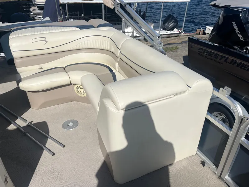 Slide: The Image of 2009 Bennington 2275 GS boat interior with beige seating and lake view. - 8