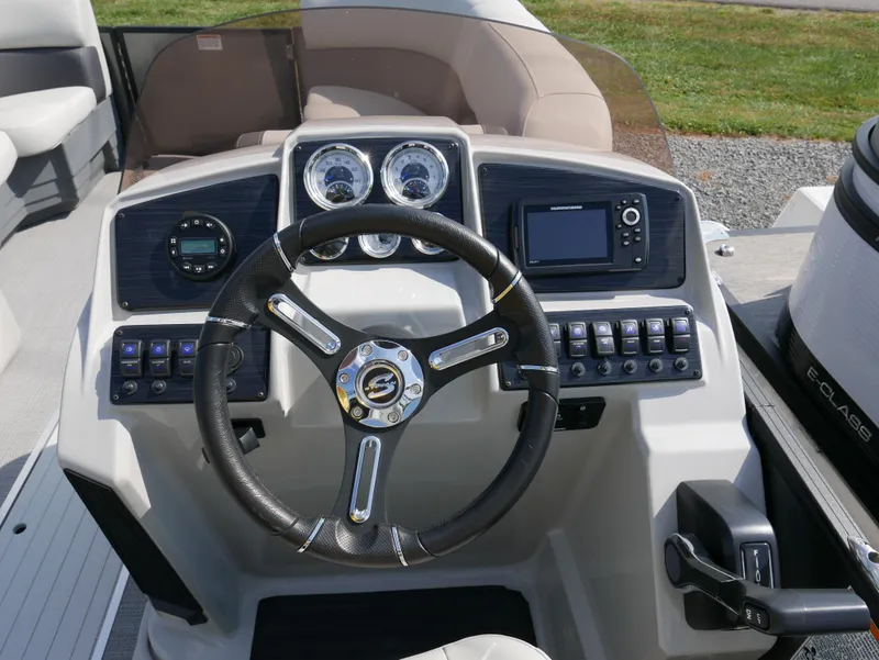 Slide: The Image of 2023 Sylvan Mirage X X3 boat dashboard with steering wheel and control panel. - 14