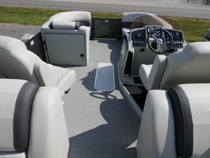 Slide: The Image of 2023 Sylvan Mirage X X3 pontoon boat interior with plush seating and modern dashboard. - 19