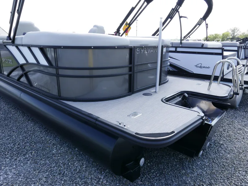 Slide: The Image of 2023 Sylvan Mirage X X3 pontoon boat on gravel lot, side view. - 4