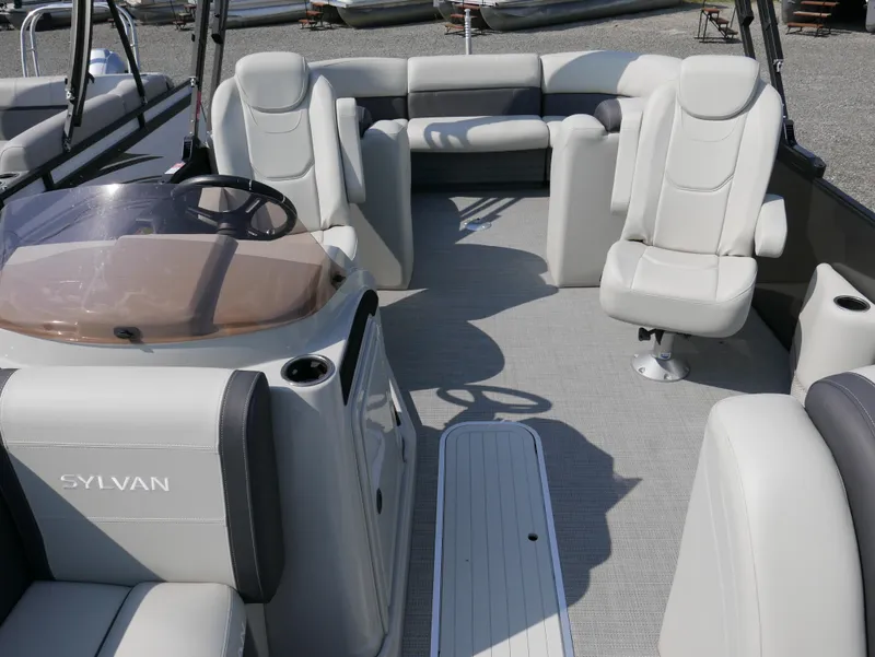 Slide: The Image of 2023 Sylvan Mirage X X3 pontoon boat interior with plush seating and modern design. - 9