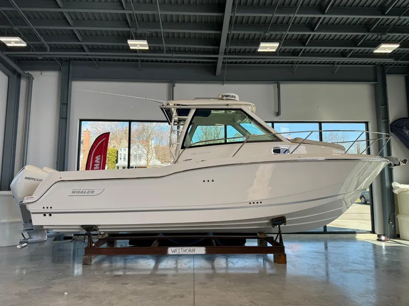 Slide: The Image of 2024 Boston Whaler 285 Conquest boat displayed indoors. - 0