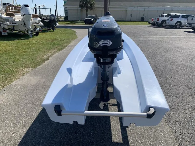 Slide: The Image of 2023 Solo Skiff 14 with outboard motor on a sunny day. - 2