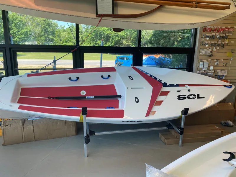 The Image of 2024 Dinghy Sol Sailboat on display in a showroom. - 0