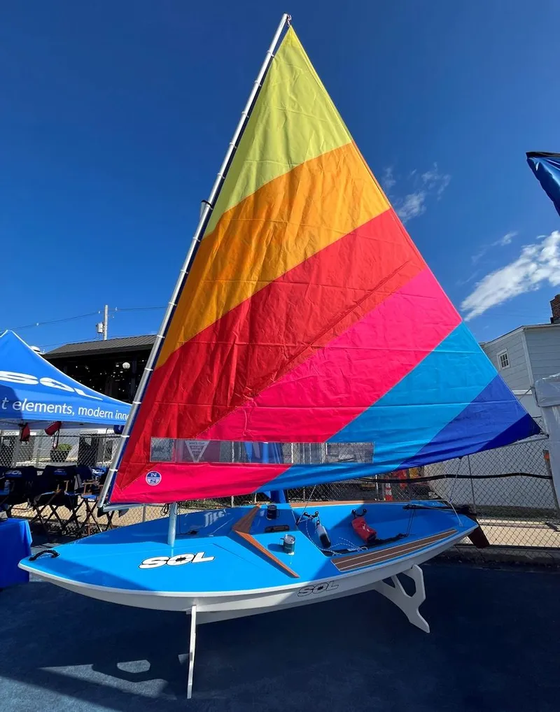 Slide: The Image of 2024 Dinghy Sol Sailboat with colorful sail on display. - 14