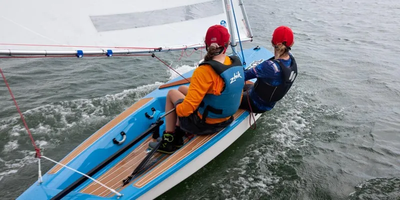 Slide: The Image of 2024 Dinghy Sol Sailboat with two sailors on the water. - 16