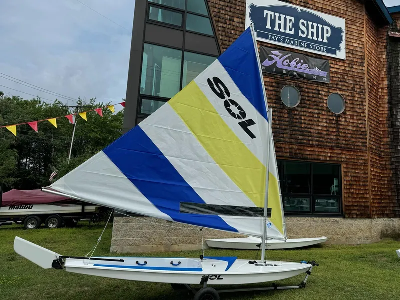 Slide: The Image of 2024 Dinghy Sol Sailboat displayed outside Fay's Marine Store. - 2