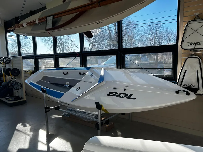 Slide: The Image of 2024 Dinghy Sol Sailboat displayed indoors with accessories. - 4