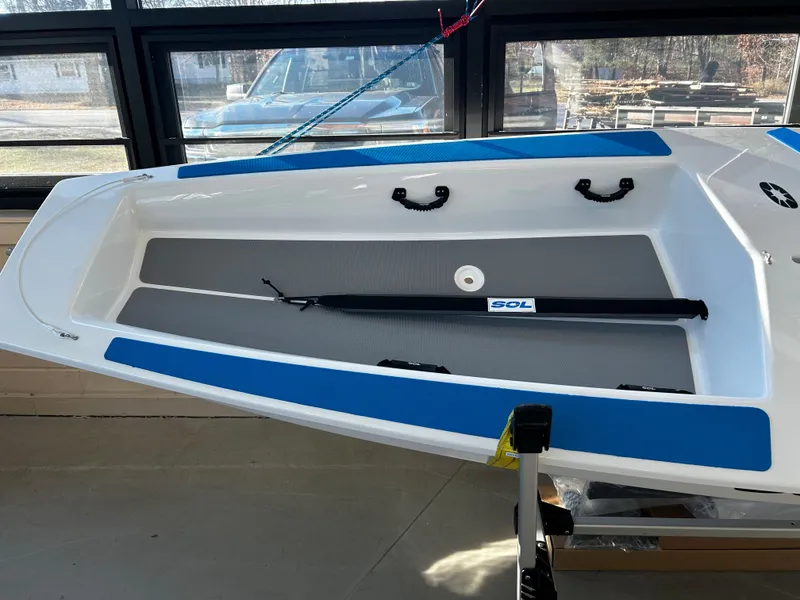 Slide: The Image of 2024 Dinghy Sol Sailboat interior view with blue and white accents. - 7