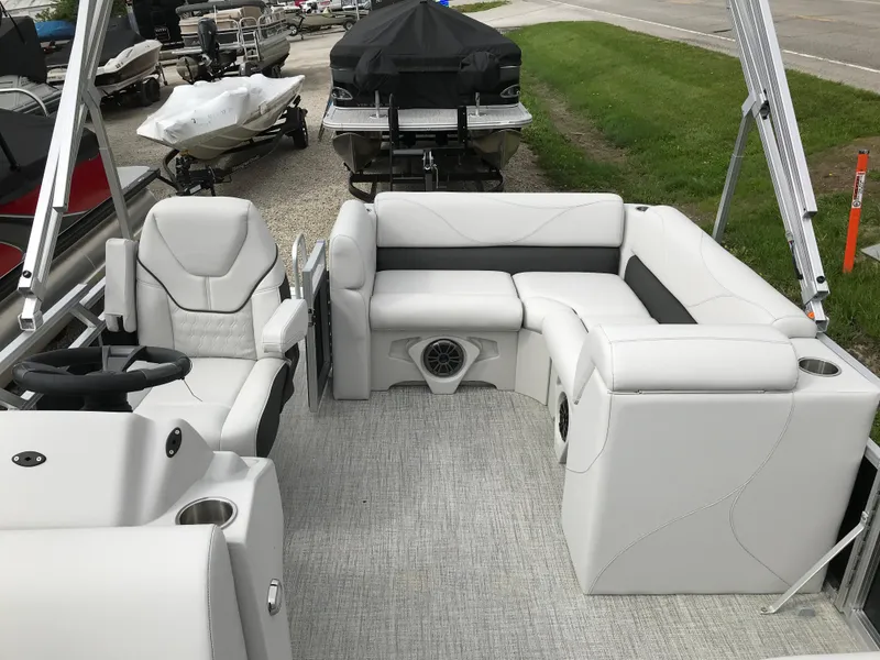Slide: The Image of 2024 Avalon VTX Cruise boat interior with white seating and modern dashboard. - 7