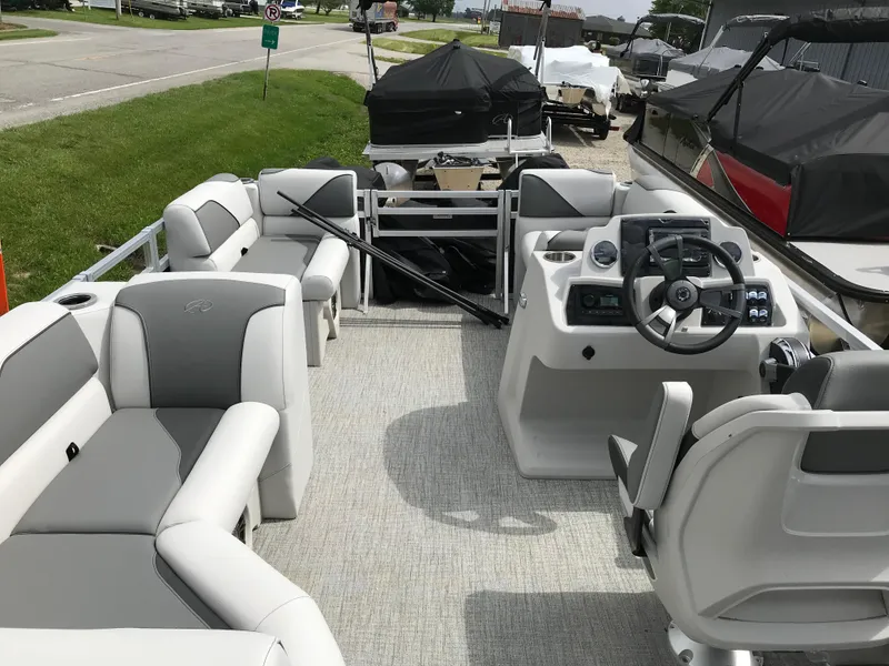 Slide: The Image of 2024 Avalon VTX Cruise boat steering console with modern controls and cup holders. - 9