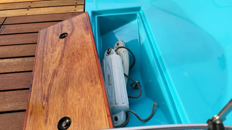 Slide: The Image of 1968 Boston Whaler 16 Sakonnet boat storage compartment with wooden lid and marine equipment. - 11