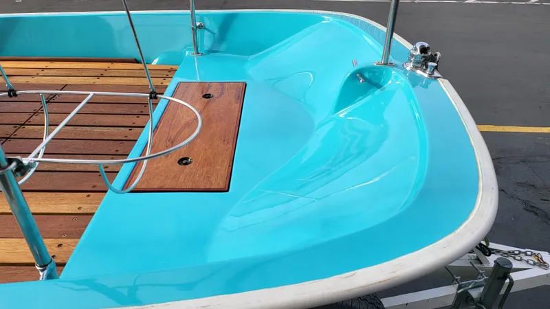 Slide: The Image of 1968 Boston Whaler 16 Sakonnet boat with turquoise interior and wooden deck. - 12