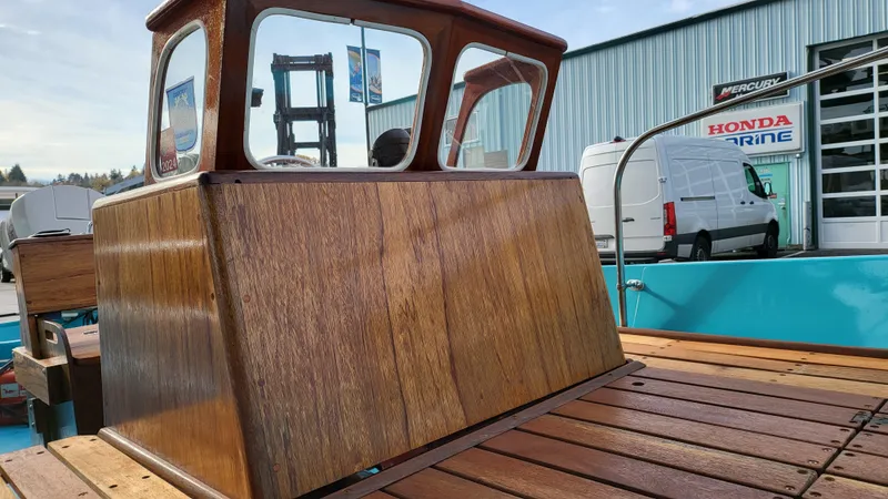 Slide: The Image of 1968 Boston Whaler 16 Sakonnet wooden console and deck in a marina. - 13