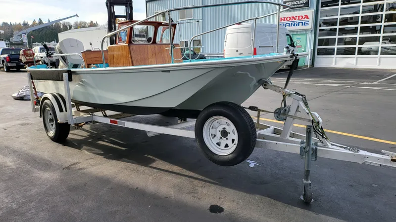 Slide: The Image of 1968 Boston Whaler 16 Sakonnet boat on a trailer in a marina parking lot. - 14