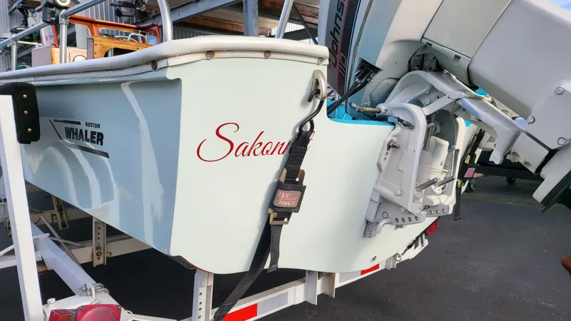 Slide: The Image of 1968 Boston Whaler 16 Sakonnet boat on trailer, rear view with motor. - 2