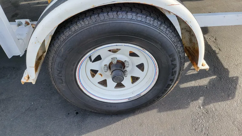 Slide: The Image of Trailer wheel of a 1968 Boston Whaler 16 Sakonnet boat. - 22