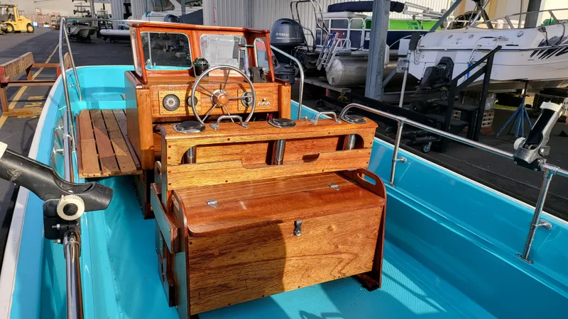 Slide: The Image of 1968 Boston Whaler 16 Sakonnet boat with wooden console and blue interior. - 6