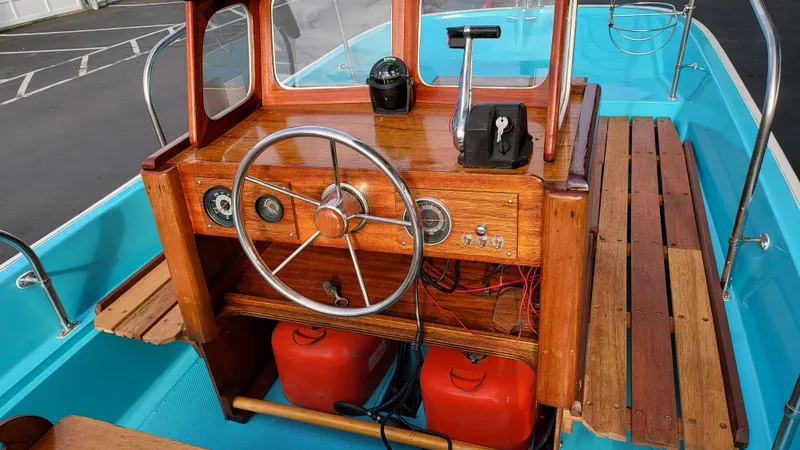 Slide: The Image of 1968 Boston Whaler 16 Sakonnet boat interior with wooden console and steering wheel. - 7