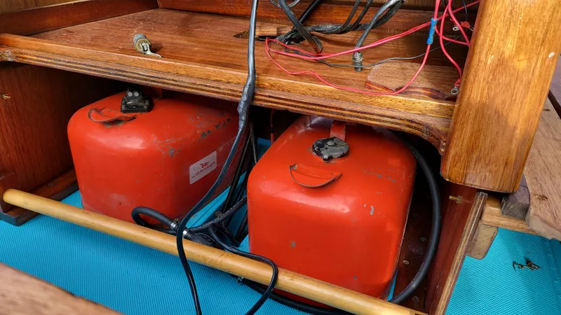 Slide: The Image of 1968 Boston Whaler 16 Sakonnet fuel tanks and wiring under wooden console. - 9