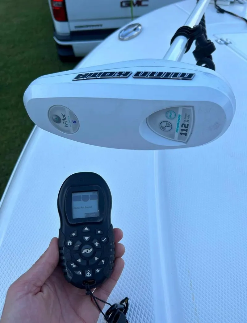 Slide: The Image of 2019 Robalo 246 Cayman boat with Minn Kota trolling motor and remote control. - 11