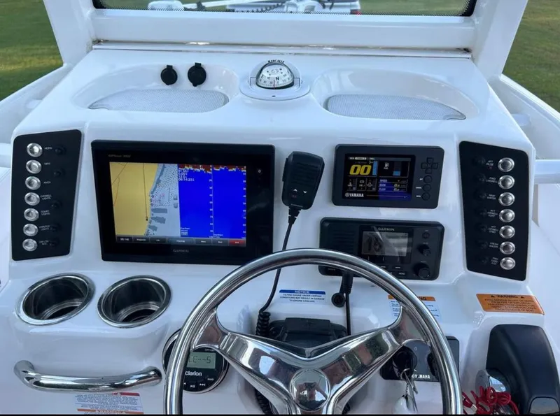 Slide: The Image of 2019 Robalo 246 Cayman boat dashboard with navigation and control systems. - 6