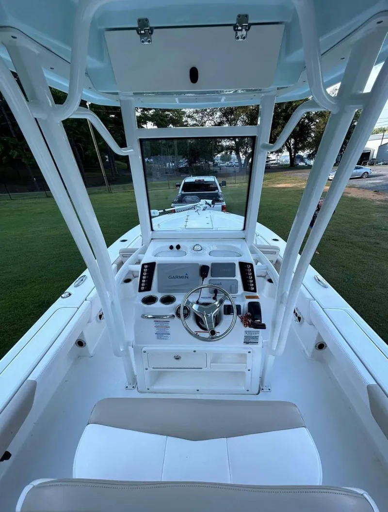 Slide: The Image of 2019 Robalo 246 Cayman boat interior with steering console and seating. - 8
