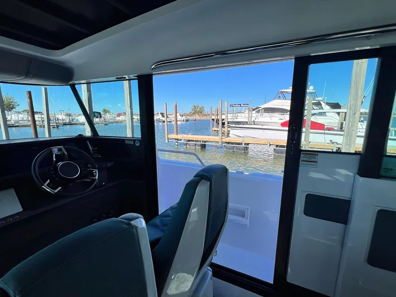 Slide: The Image of Interior view of 2024 Axopar 45 XC Cross Cabin overlooking marina. - 10
