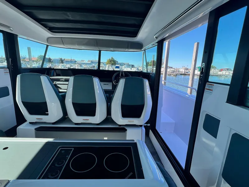 Slide: The Image of Interior of 2024 Axopar 45 XC Cross Cabin with modern seating and panoramic windows. - 11