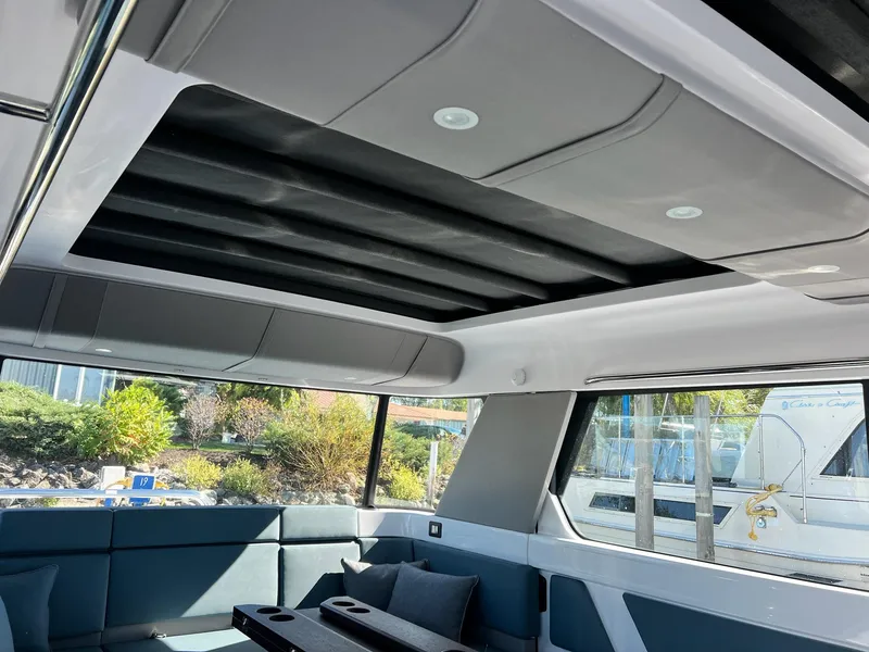 Slide: The Image of Interior of 2024 Axopar 45 XC Cross Cabin with modern seating and panoramic windows. - 13