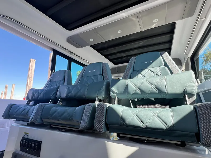 Slide: The Image of 2024 Axopar 45 XC Cross Cabin interior with luxurious seating and panoramic windows. - 14