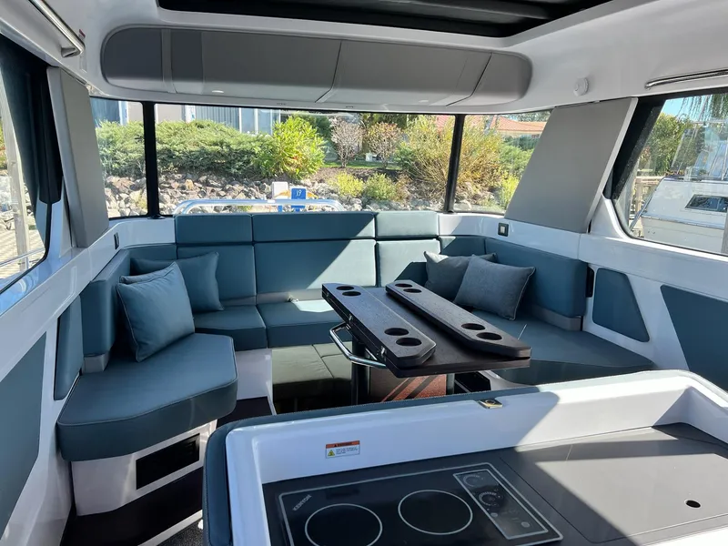 Slide: The Image of Luxurious interior of 2024 Axopar 45 XC Cross Cabin with modern seating and table. - 15