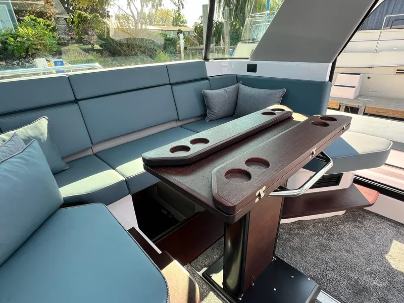 Slide: The Image of Luxurious seating area in 2024 Axopar 45 XC Cross Cabin with modern table design. - 17