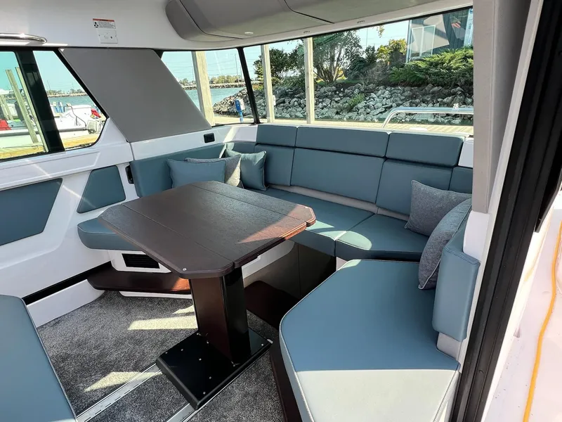 Slide: The Image of 2024 Axopar 45 XC Cross Cabin interior with modern seating and table. - 18