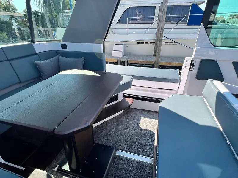Slide: The Image of Interior of 2024 Axopar 45 XC Cross Cabin with modern seating and table. - 19
