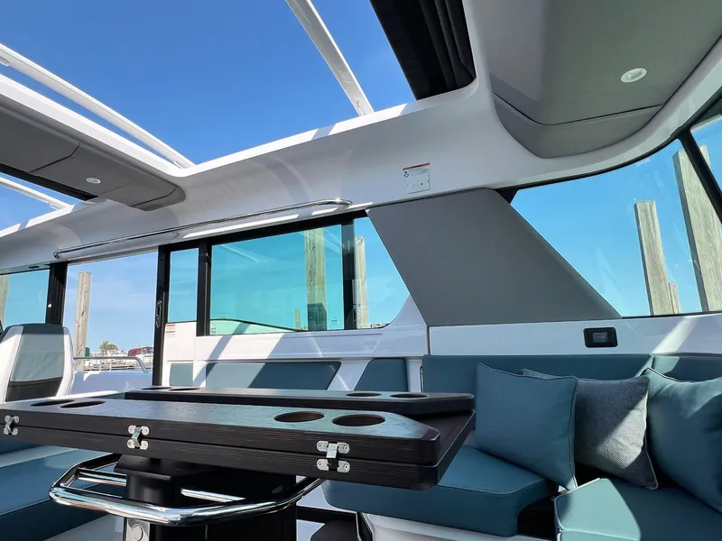 Slide: The Image of Interior of 2024 Axopar 45 XC Cross Cabin with modern seating and table. - 21
