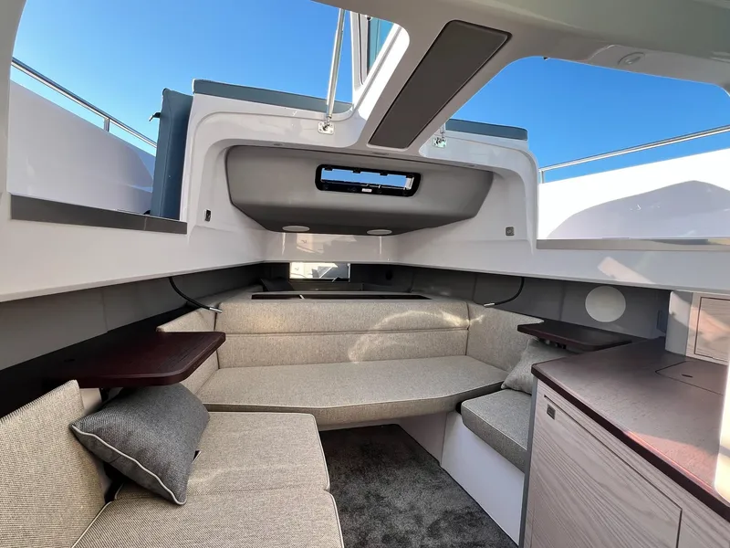 Slide: The Image of 2024 Axopar 45 XC Cross Cabin interior with modern seating and sleek design. - 26