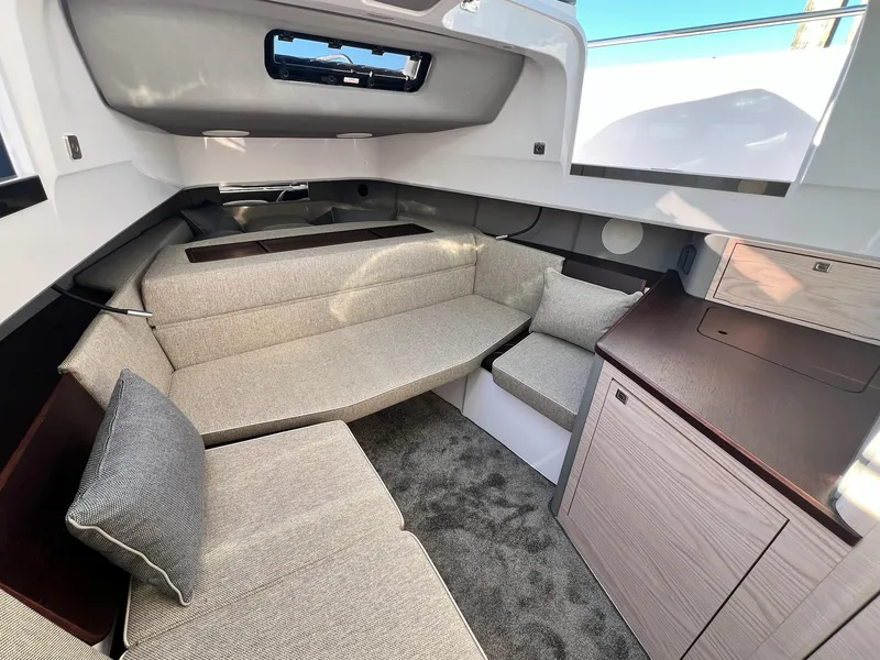 Slide: The Image of 2024 Axopar 45 XC Cross Cabin interior with modern seating and cabinetry. - 28