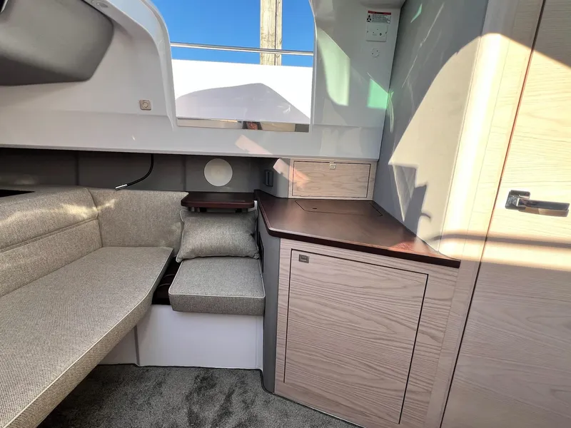 Slide: The Image of 2024 Axopar 45 XC Cross Cabin interior with modern seating and cabinetry. - 29