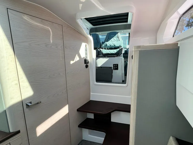 Slide: The Image of Interior of 2024 Axopar 45 XC Cross Cabin, featuring modern design and wood accents. - 32