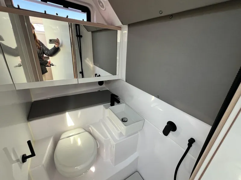 Slide: The Image of 2024 Axopar 45 XC Cross Cabin bathroom with modern fixtures and sleek design. - 35