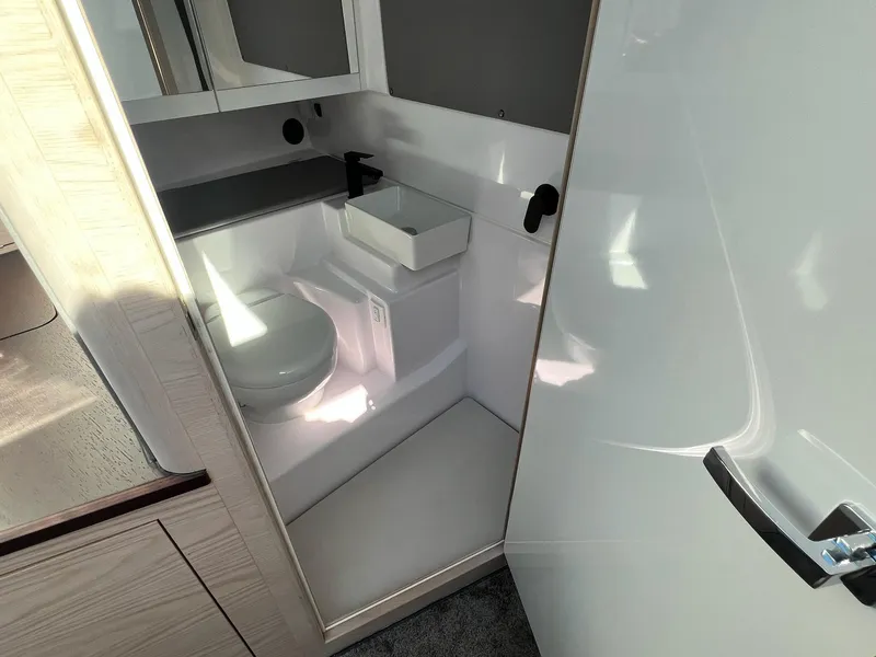 Slide: The Image of 2024 Axopar 45 XC Cross Cabin bathroom interior with modern fixtures and compact design. - 37
